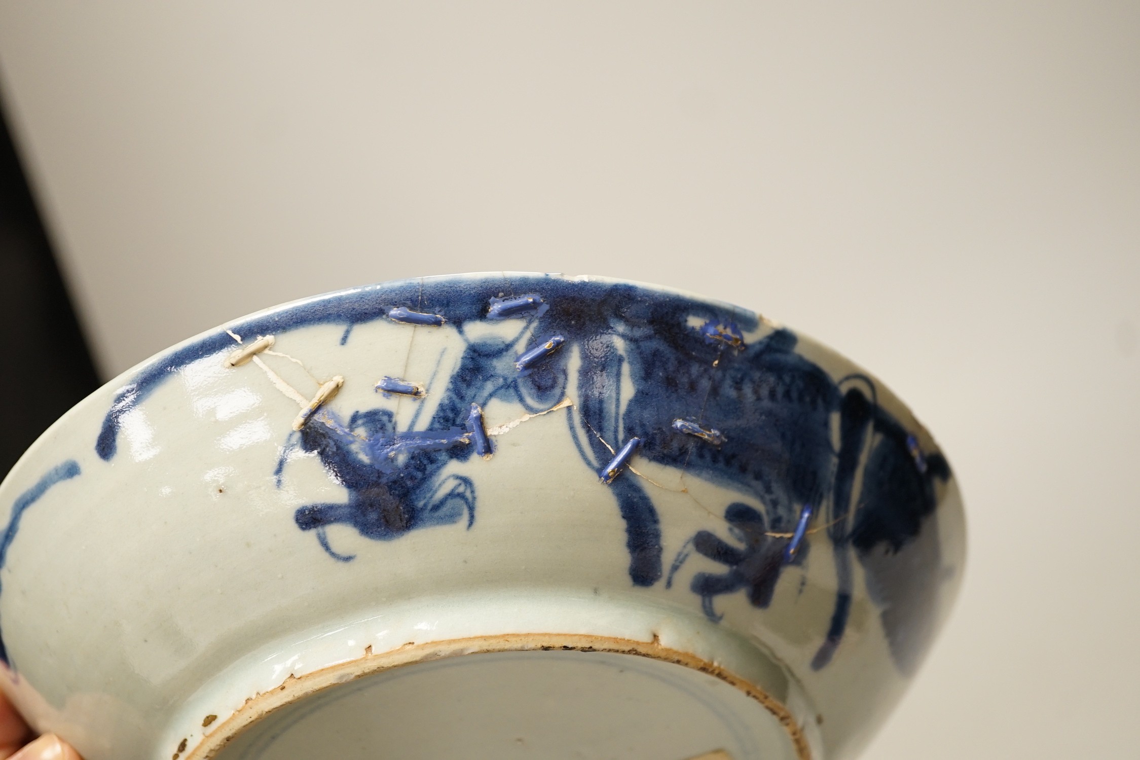 Two 19th century Chinese blue and white dishes and two 18th century tea bowls, largest 23cm diameter
